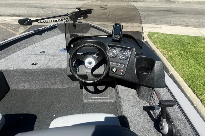 Slide: The Image of 2027 Tracker Pro Guide V-16 SC boat dashboard with steering wheel and gauges. - 20