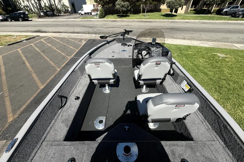 Slide: The Image of 2027 Tracker Pro Guide V-16 SC boat interior with seating and steering console. - 19