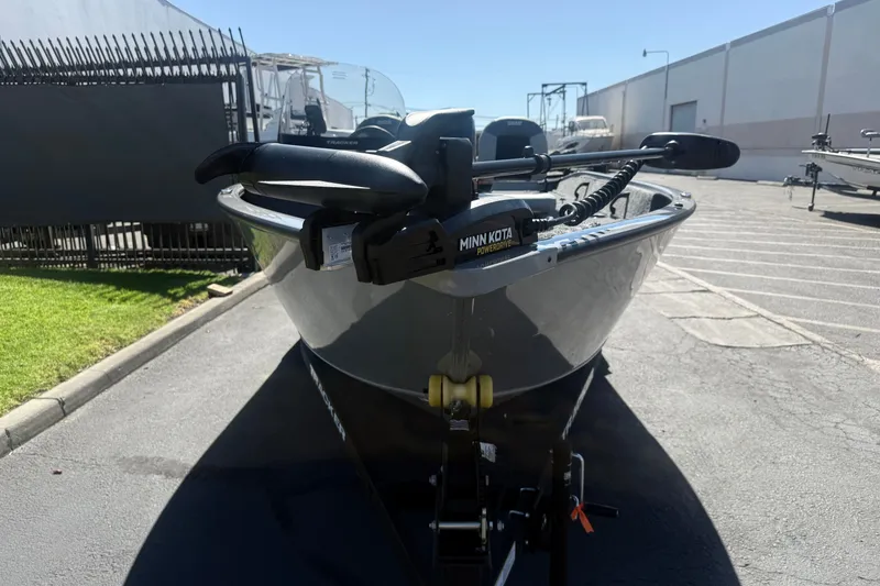 Slide: The Image of 2027 Tracker Pro Guide V-16 SC boat with Minn Kota motor in parking lot. - 13