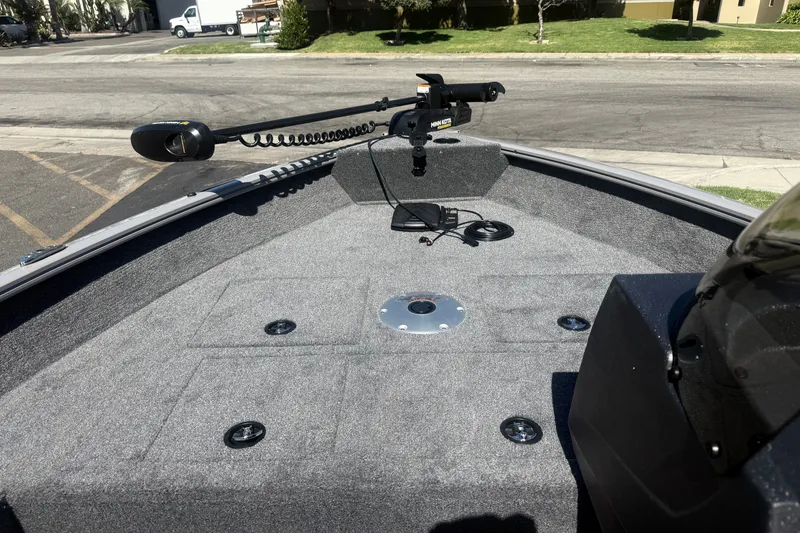 Slide: The Image of 2027 Tracker Pro Guide V-16 SC boat deck with trolling motor and carpeted surface. - 15