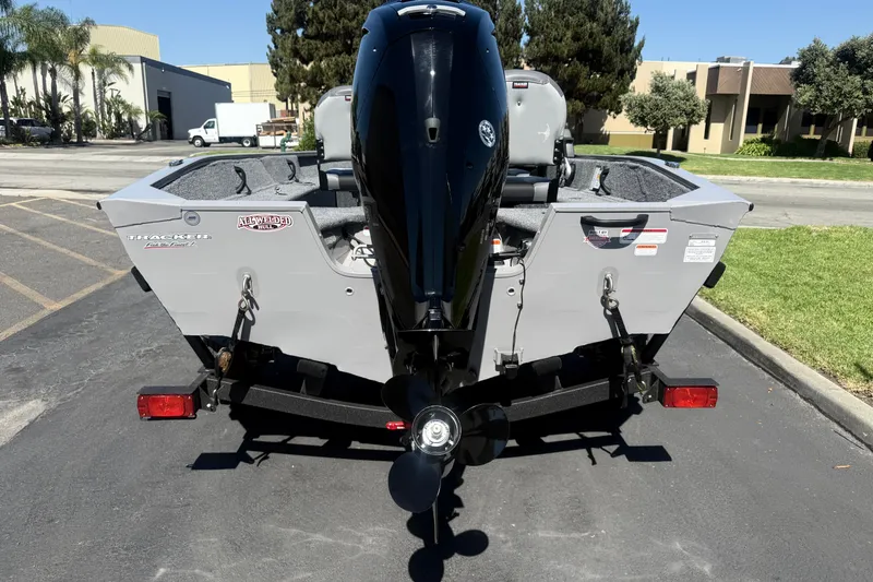 Slide: The Image of 2027 Tracker Pro Guide V-16 SC boat on trailer, rear view in parking lot. - 16