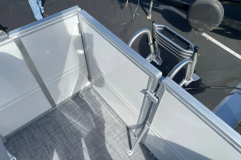 Slide: The Image of 2027 Sun Tracker Party Barge 16 DLX interior with open gate and ladder. - 15