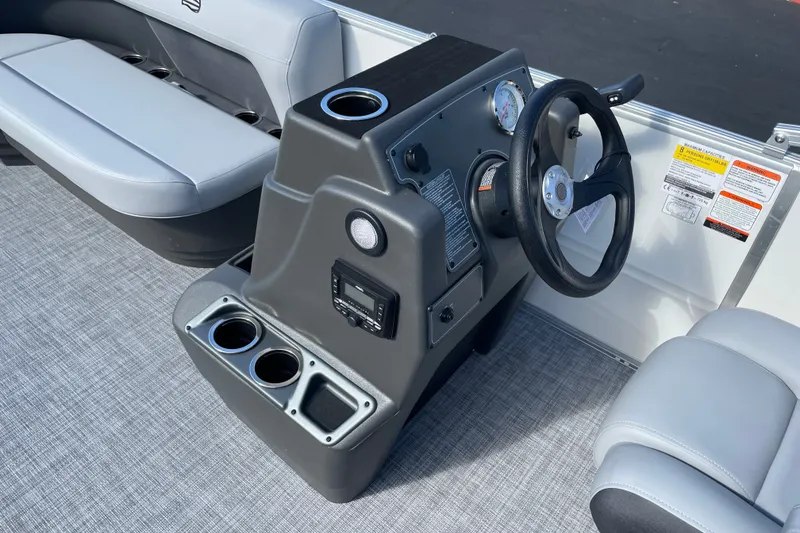 Slide: The Image of 2027 Sun Tracker Party Barge 16 DLX boat interior with steering console and seating. - 13