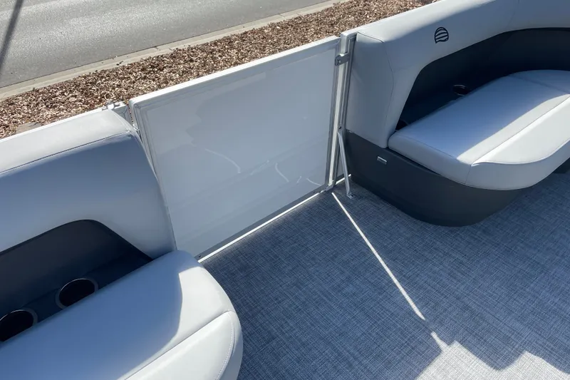 Slide: The Image of 2027 Sun Tracker Party Barge 16 DLX interior with gray seating and cup holders. - 17