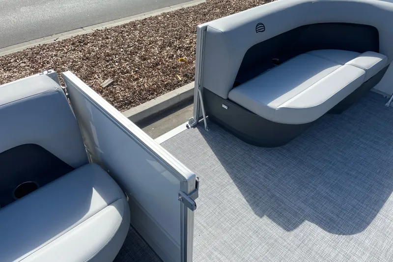 Slide: The Image of 2027 Sun Tracker Party Barge 16 DLX interior with gray seating and flooring. - 18