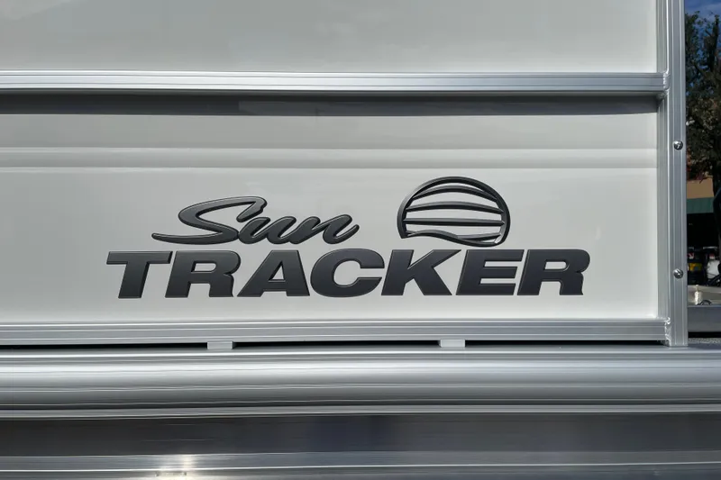 Slide: The Image of 2027 Sun Tracker Party Barge 16 DLX logo on boat exterior. - 21