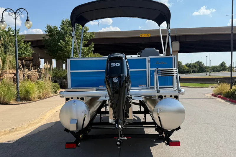 Slide: The Image of 2027 Sun Tracker Party Barge 16 DLX pontoon boat with 50 HP engine, parked outdoors. - 14