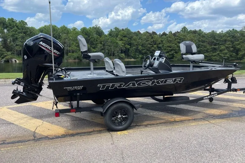 The Image of 2027 Tracker Pro Team 175 Crappie Edition boat on trailer, parked near a lake. - 0