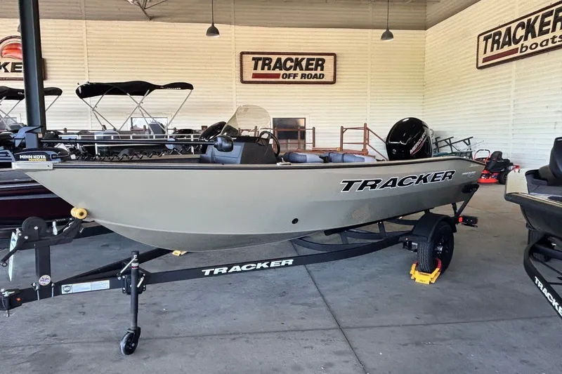 The Image of 2027 Tracker Pro Guide V-16 SC boat on trailer in showroom. - 0