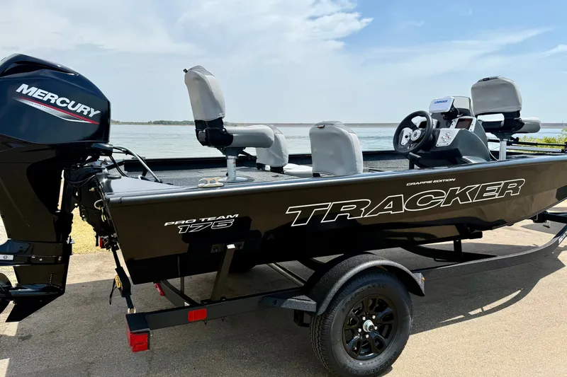 Slide: The Image of 2027 Tracker Pro Team 175 Crappie Edition boat with Mercury engine by the water. - 13