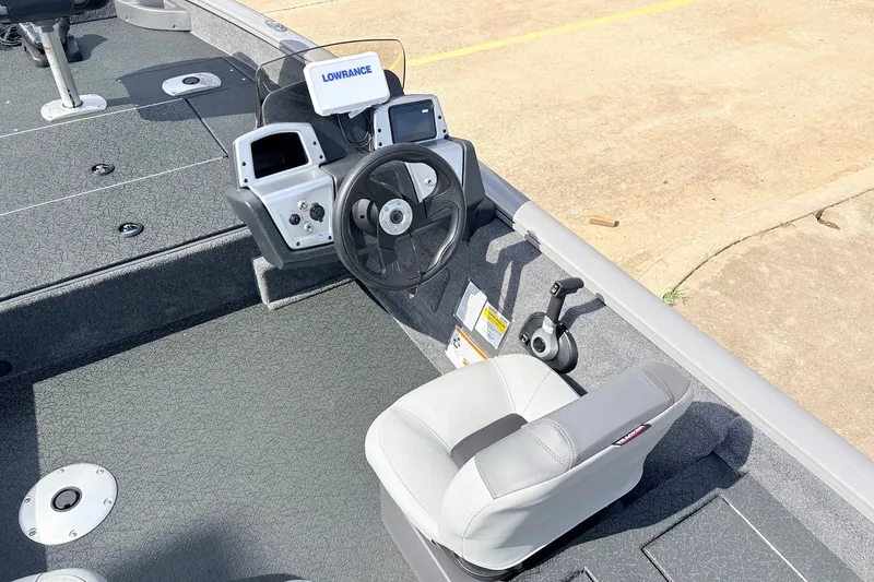 Slide: The Image of 2027 Tracker Pro Team 175 Crappie Edition boat interior with steering console and seating. - 23