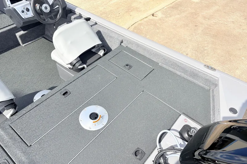 Slide: The Image of 2027 Tracker Pro Team 175 Crappie Edition boat interior with seating and steering wheel. - 34