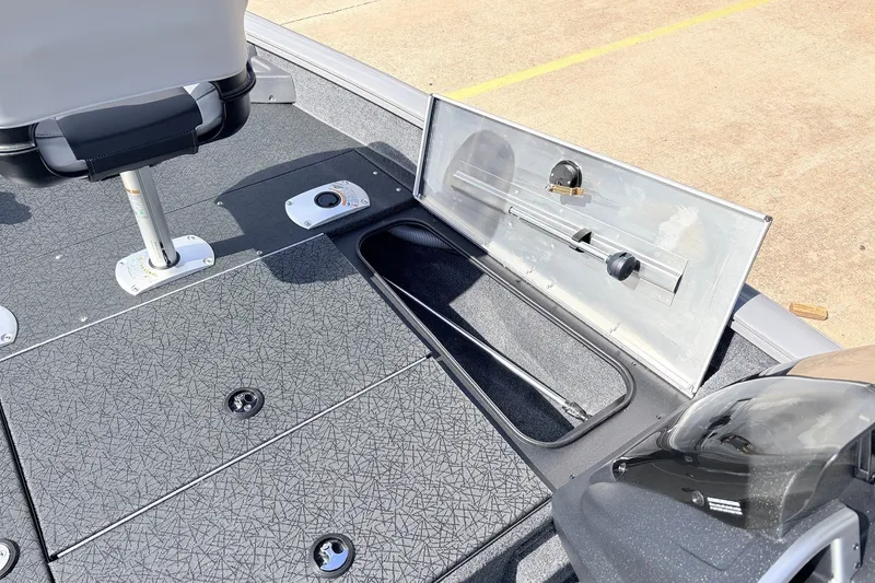 Slide: The Image of 2027 Tracker Pro Team 175 Crappie Edition boat interior with storage compartment open. - 16