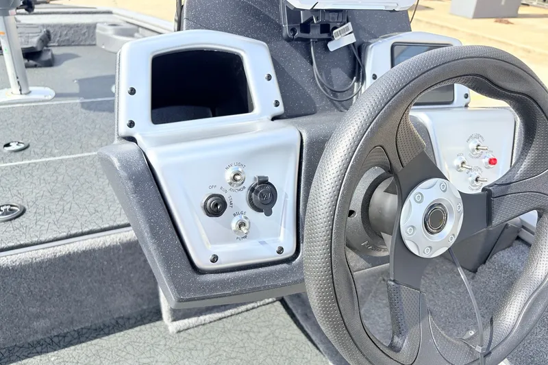 Slide: The Image of Steering console of 2027 Tracker Pro Team 175 Crappie Edition boat, featuring control panel and wheel. - 25