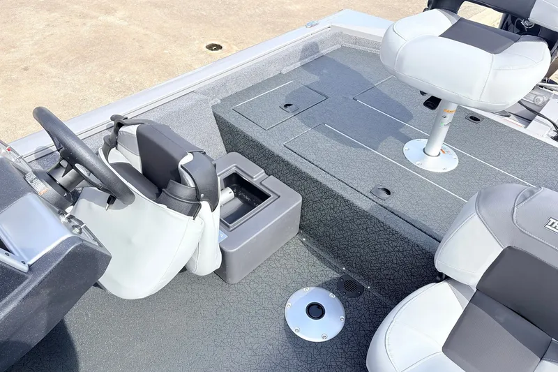 Slide: The Image of 2027 Tracker Pro Team 175 Crappie Edition boat interior with seating and steering wheel. - 22