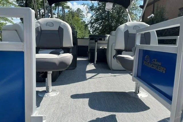 Slide: The Image of 2027 Sun Tracker Fishin' Barge 20 DLX interior with seating and steering console. - 13