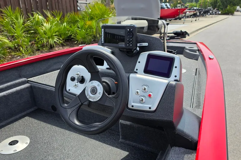 Slide: The Image of 2027 Tracker Pro Team 175 Crappie Edition boat dashboard with steering wheel and electronic displays. - 13