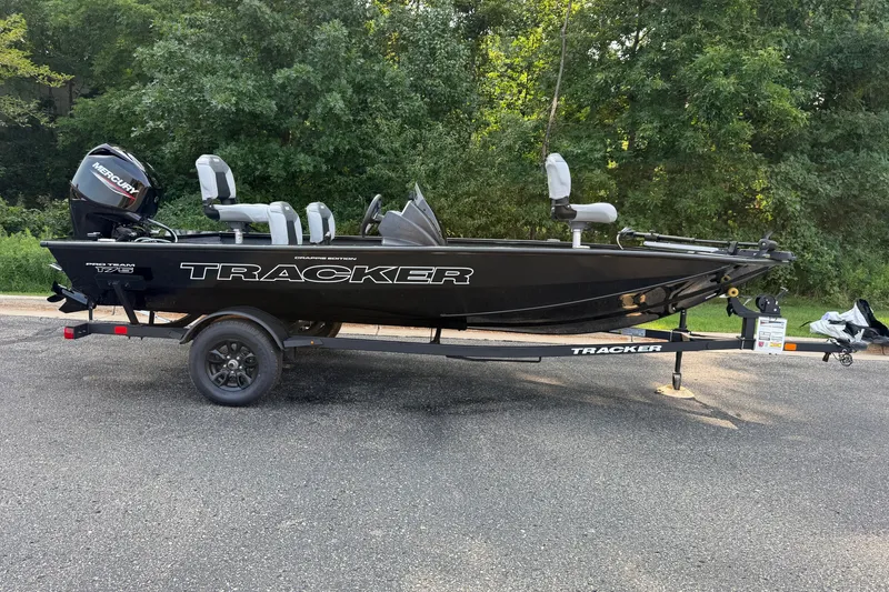 The Image of 2027 Tracker Pro Team 175 Crappie Edition boat on trailer, parked outdoors. - 0