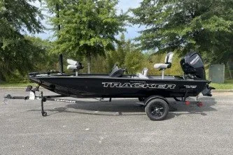 The Image of 2027 Tracker Pro Team 175 Crappie Edition boat on trailer, parked outdoors. - 0