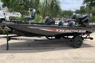 The Image of 2027 Tracker Pro Team 175 Crappie Edition boat on trailer, parked outdoors. - 0