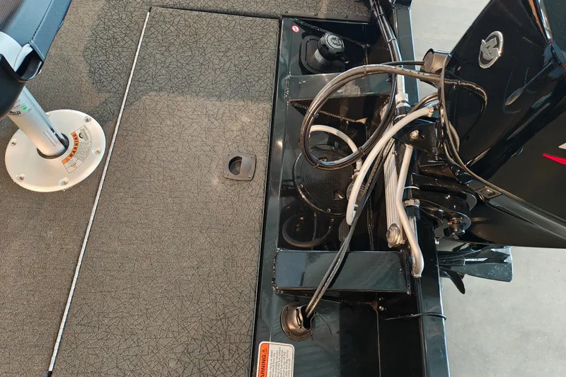 Slide: The Image of 2027 Tracker Pro Team 175 Crappie Edition boat interior, featuring seating and engine components. - 30