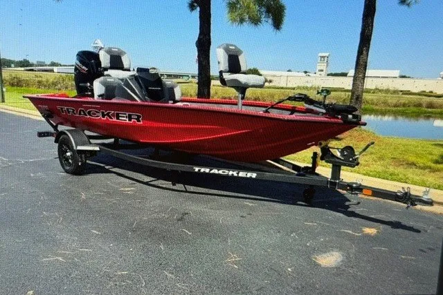 Slide: The Image of 2027 Tracker Pro Team 175 Crappie Edition boat in vibrant red on a trailer. - 14