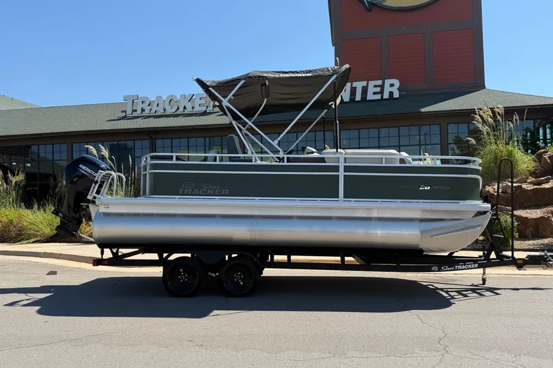 Slide: The Image of 2027 Sun Tracker Fishin' Barge 20 DLX pontoon boat on trailer outside dealership. - 13