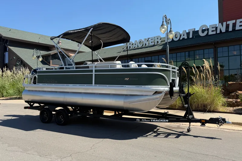 Slide: The Image of 2027 Sun Tracker Fishin' Barge 20 DLX pontoon boat on trailer outside dealership. - 14