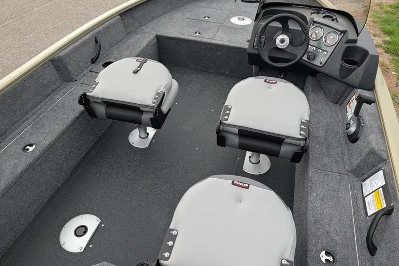 Slide: The Image of Interior of 2027 Tracker Pro Guide V-16 SC boat with seating and steering console. - 49