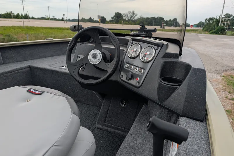 Slide: The Image of 2027 Tracker Pro Guide V-16 SC boat dashboard with steering wheel and gauges. - 48