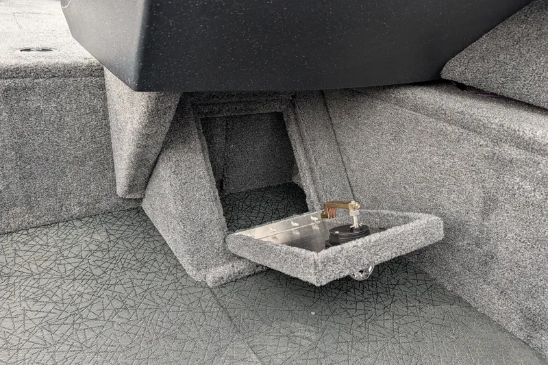 Slide: The Image of 2027 Tracker Pro Guide V-16 SC boat interior with carpeted storage compartment. - 57