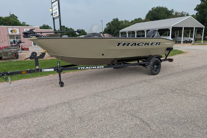 The Image of 2027 Tracker Pro Guide V-16 SC boat on trailer, parked outdoors. - 30