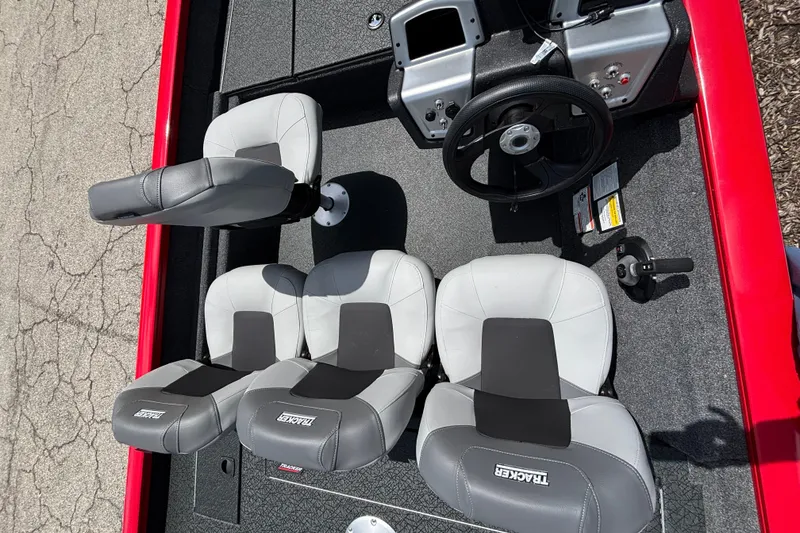 Slide: The Image of 2027 Tracker Pro Team 175 Crappie Edition boat interior with steering wheel and seating. - 34