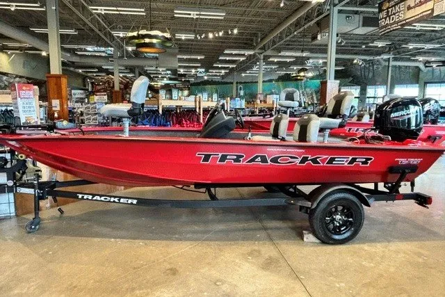 The Image of Red 2027 Tracker Pro Team 175 Crappie Edition boat displayed indoors on a trailer. - 0
