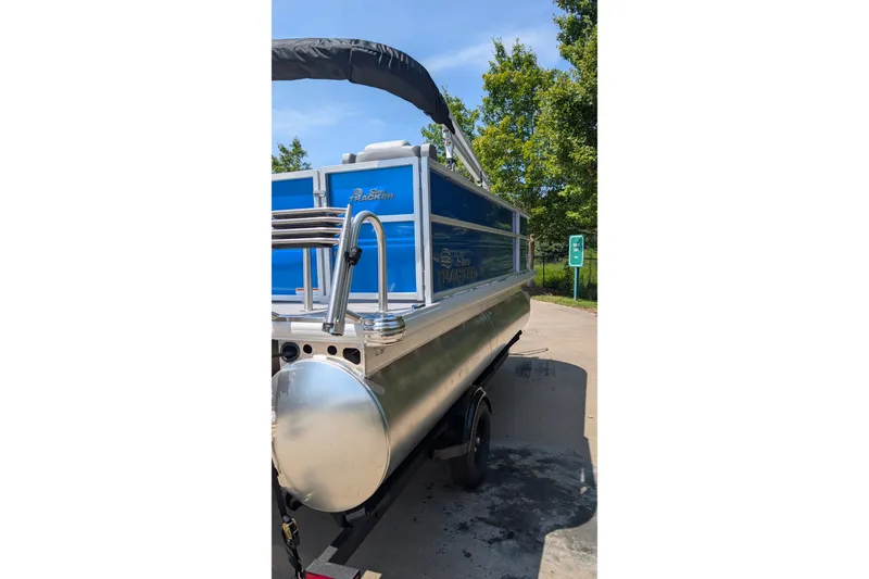 Slide: The Image of 2027 Sun Tracker Party Barge 16 DLX pontoon boat parked outdoors. - 17