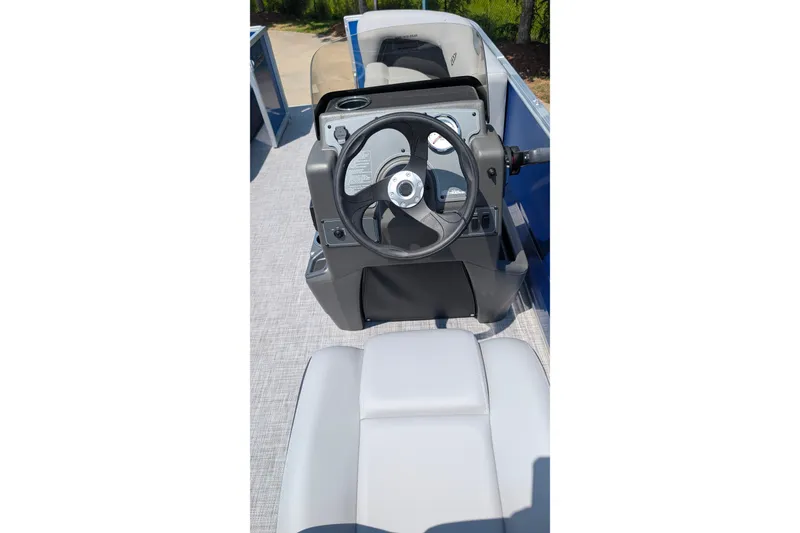 Slide: The Image of 2027 Sun Tracker Party Barge 16 DLX steering console with comfortable seating. - 12