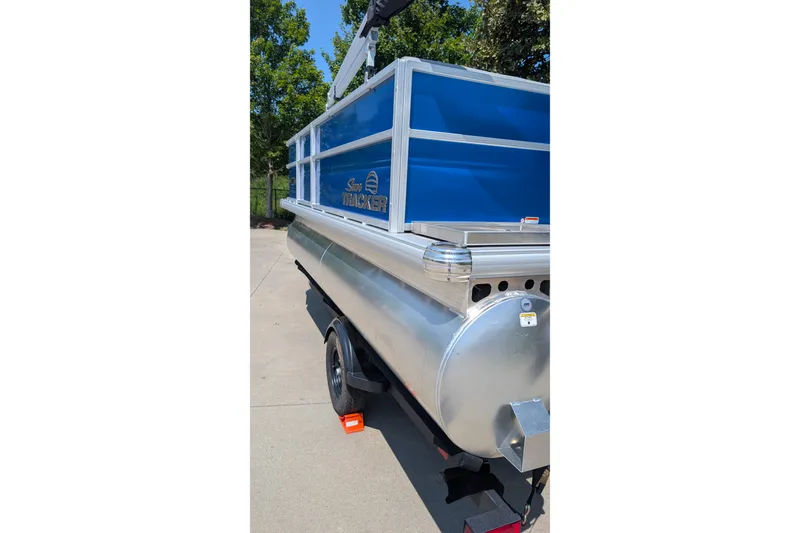 Slide: The Image of 2027 Sun Tracker Party Barge 16 DLX pontoon boat on trailer, parked outdoors. - 15