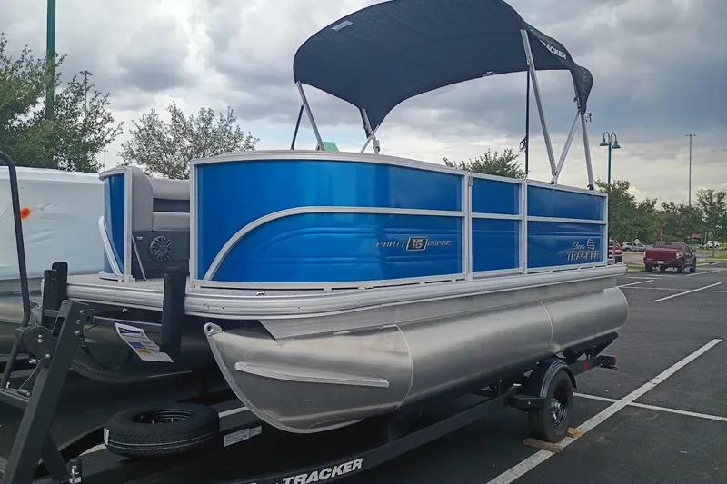 The Image of 2027 Sun Tracker Party Barge 16 DLX pontoon boat with blue exterior in parking lot. - 0