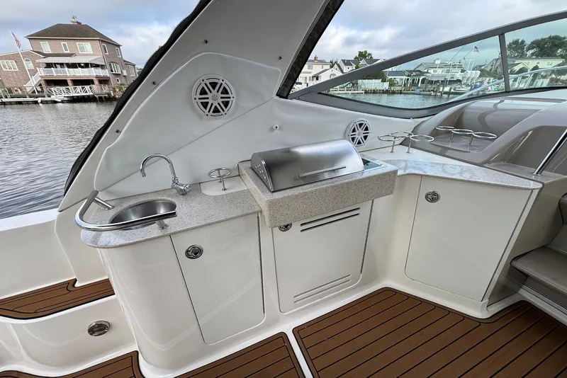 Slide: The Image of 2008 Sea Ray Sundancer 310 yacht interior with kitchenette and waterfront view. - 11