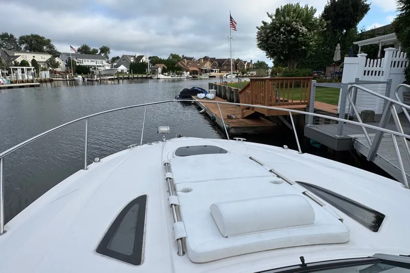 Slide: The Image of 2008 Sea Ray Sundancer 310 docked by a serene waterfront neighborhood. - 18