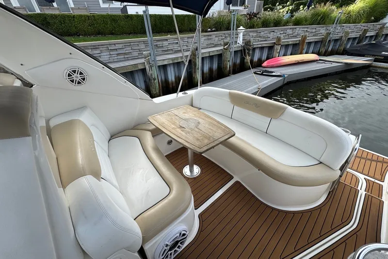 Slide: The Image of Luxurious 2008 Sea Ray Sundancer 310 boat interior with elegant seating and wooden table. - 9