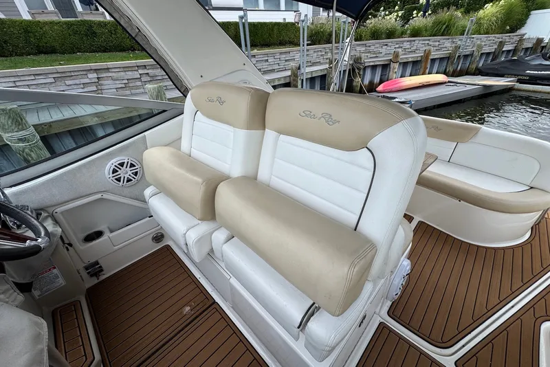 Slide: The Image of 2008 Sea Ray Sundancer 310 interior with white seating and wood flooring. - 14