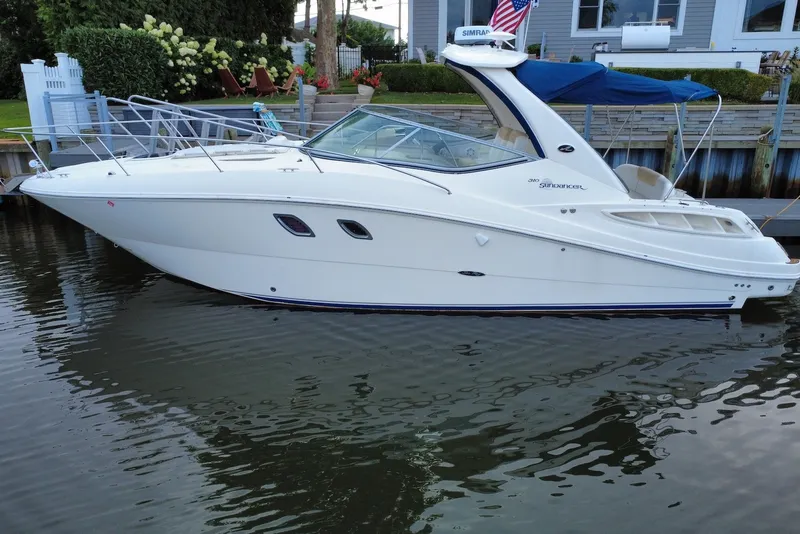The Image of 2008 Sea Ray Sundancer 310 yacht docked in calm waters, side view. - 2