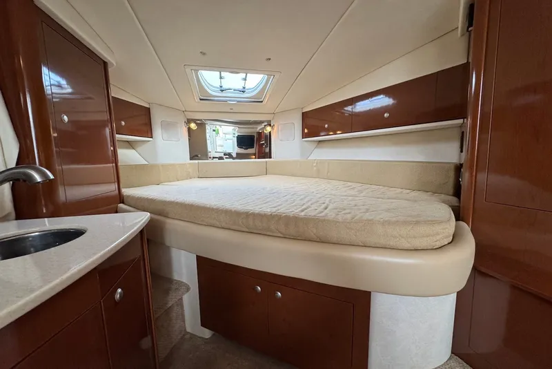 Slide: The Image of Interior cabin of 2008 Sea Ray Sundancer 310 with bed and wooden cabinetry. - 21
