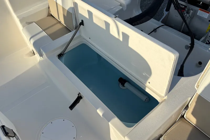 Slide: The Image of 2026 Bulls Bay 2200 XS boat interior with open storage compartment and seating. - 8