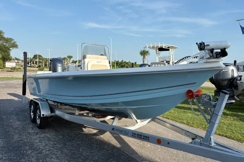Slide: The Image of 2026 Bulls Bay 2200 XS boat on trailer, parked outdoors under clear sky. - 4