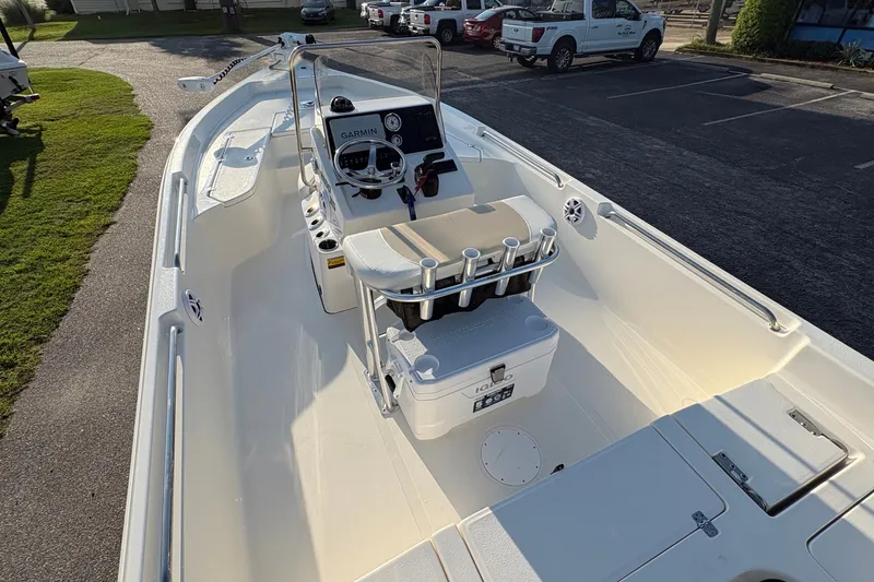 Slide: The Image of 2026 Bulls Bay 2200 XS boat interior with console and seating, parked outdoors. - 20