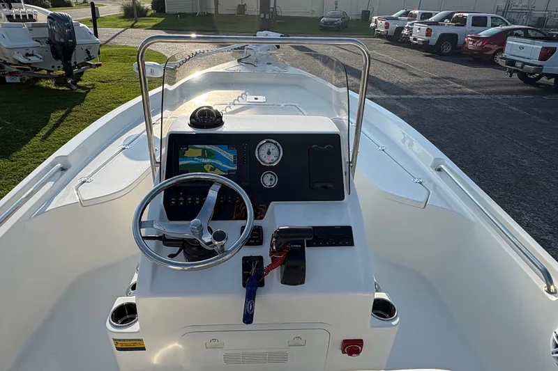 Slide: The Image of 2026 Bulls Bay 2200 XS boat dashboard with steering wheel and navigation display. - 12