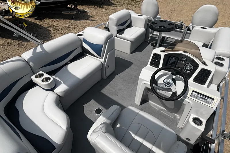 Slide: The Image of 2015 Qwest Adventure 7518 Sport Cruise boat interior with plush seating and steering console. - 10