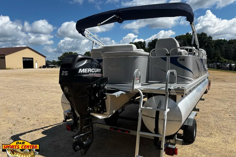 Slide: The Image of 2015 Qwest Adventure 7518 Sport Cruise pontoon boat with Mercury 25 engine on trailer. - 7